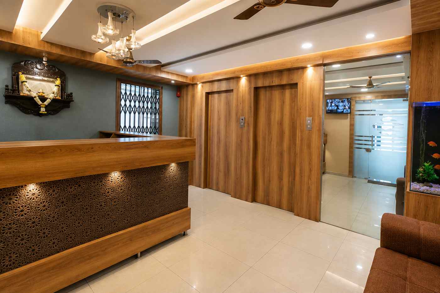 The wood-panelled reception hall and lift lobby at Hotel Samaira Residency